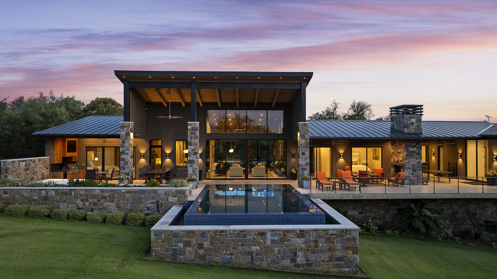 Luxury remodeled home exterior with custom outdoor living and pool design