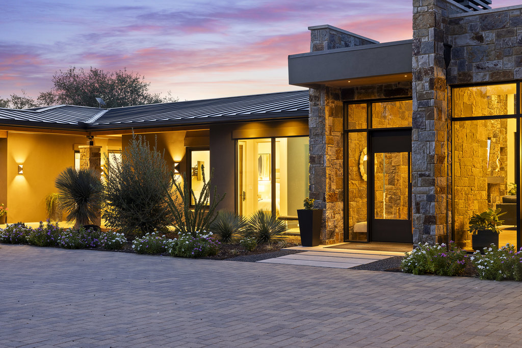 Luxury custom homes Horseshoe Bay - Spacious modern luxury home exterior with large glass windows at dusk by Westway Custom Builders